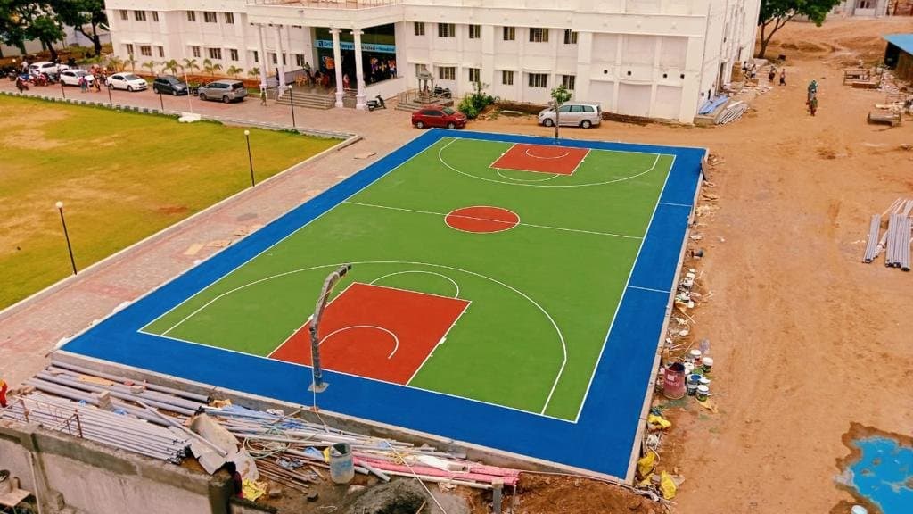 Aerial view of a green and red basketball court at Sri Chaitanya Techno School, Namakkal, built by Fitoverse