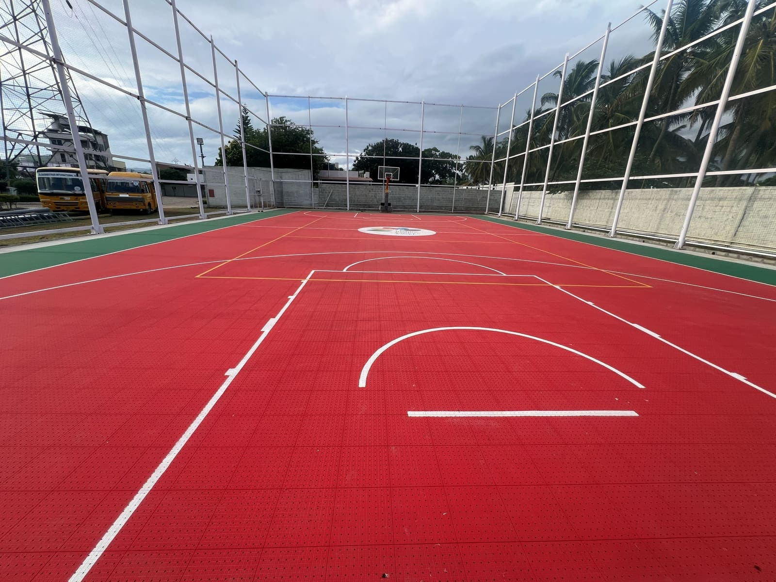 Red interlocking tile court with white markings at Dasarathan School, Coimbatore, built by Fitoverse