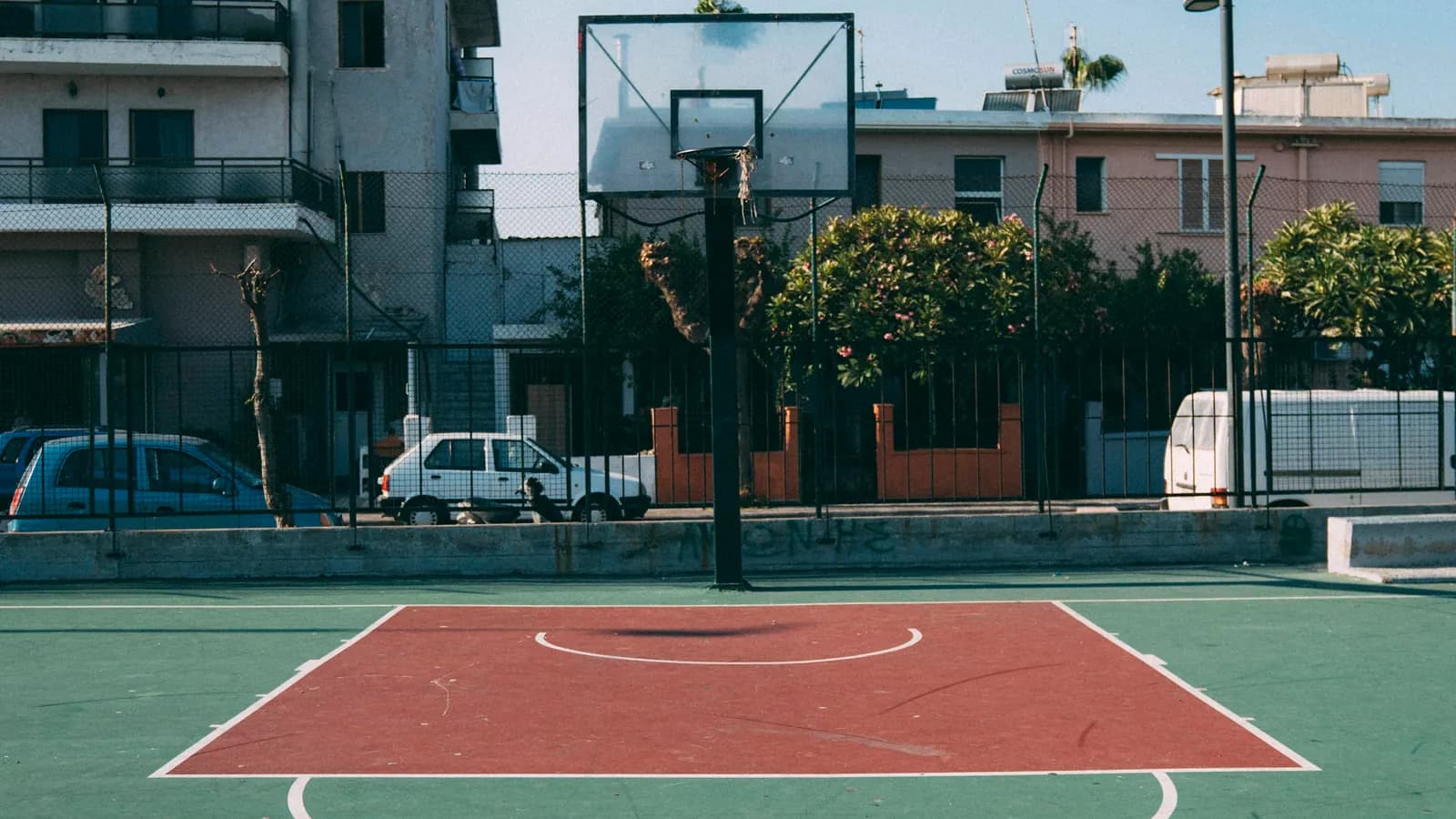 Outdoor basketball court with a hoop and painted key