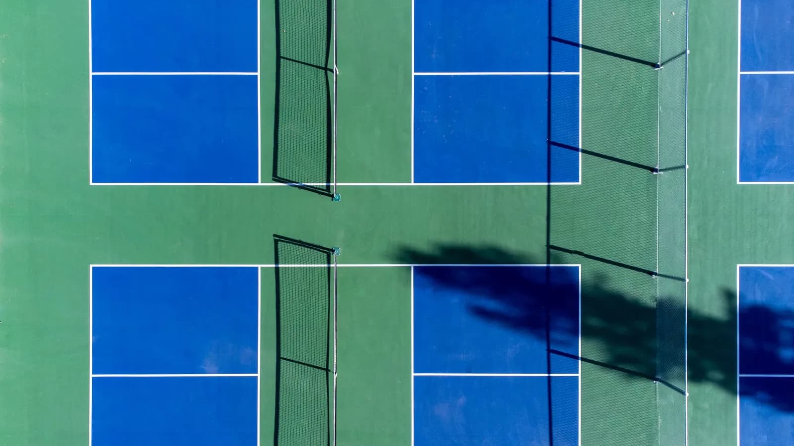 Aerial view of pickleball courts with acrylic surface and nets